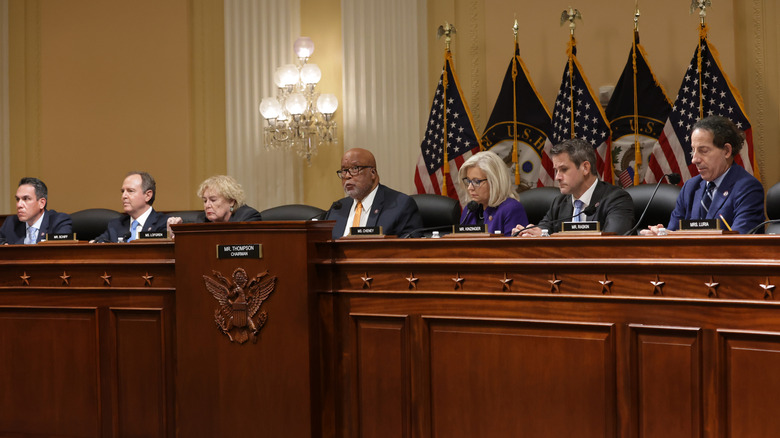 Members of the House January 6 committee sitting on dais