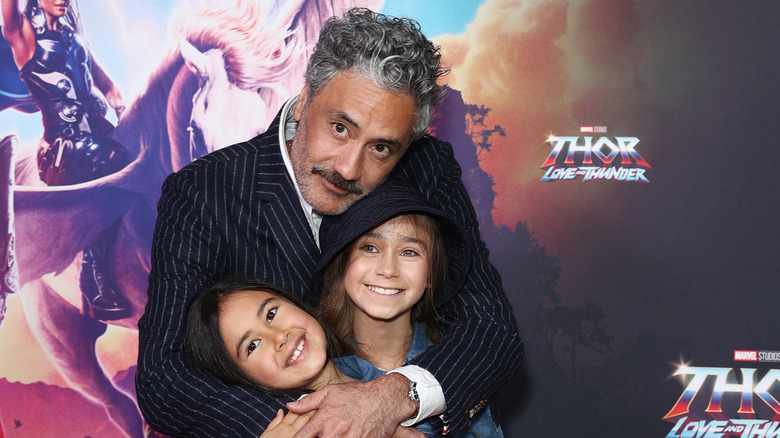 Taika Waititi posing with his children