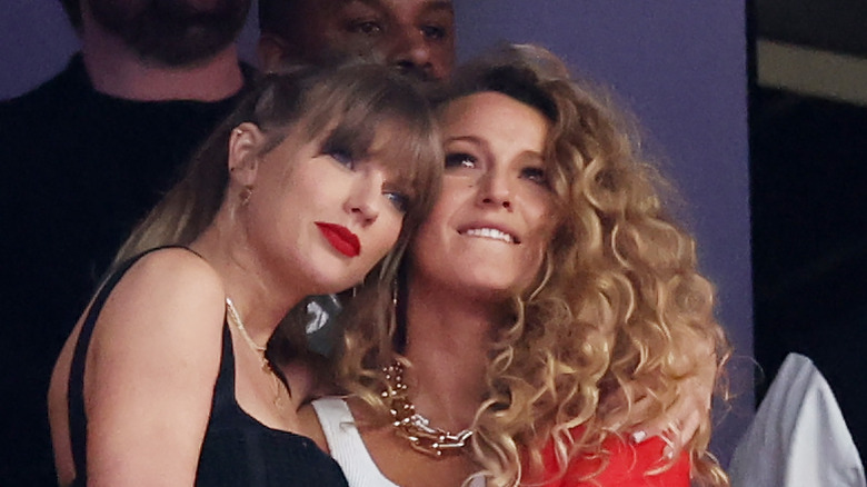 Taylor Swift and Blake Lively hugging at a game