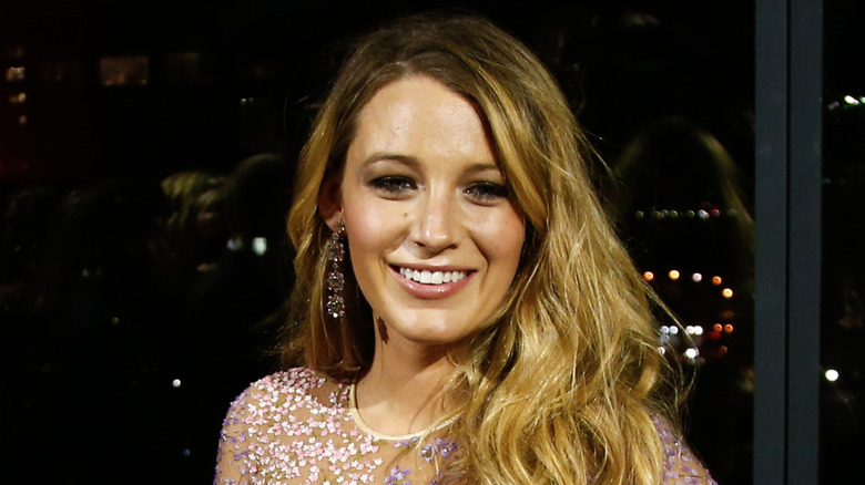 Blake Lively in a shimmering gown smiling at the camera