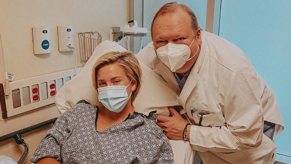 Savannah Chrisley in the hospital with a doctor, wearing masks