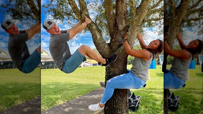 Brian and Mika Kleinschmidt smiling and climbing a tree