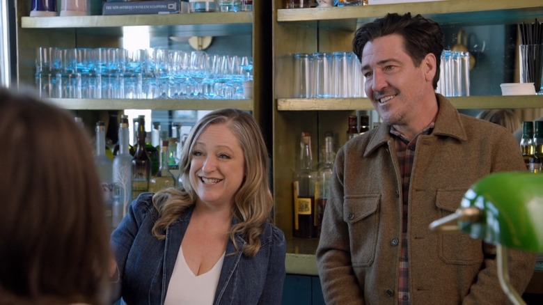 Kristina Crestin and Jonathan Knight smiling while talking to client on "Farmhouse Fixer"