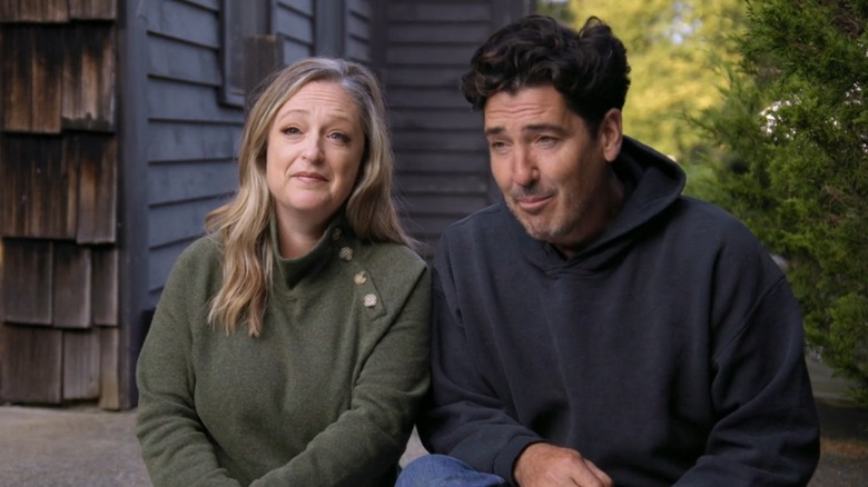 Kristina Crestin and Jonathan Knight grinning while sitting together on "Farmhouse Fixer"