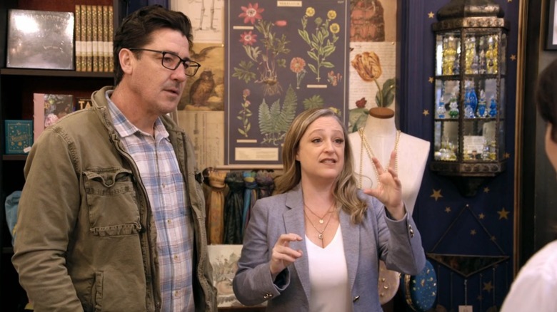 Jonathan Knight and Kristina Crestin talking to clients in an antique shop on "Farmhouse Fixer"