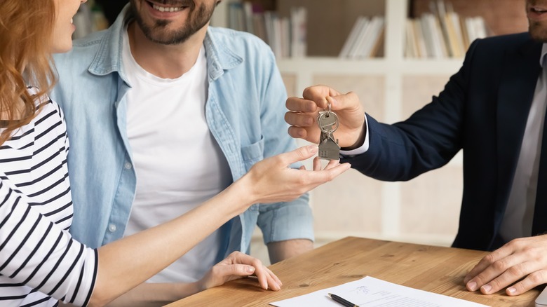 couple being handed house keys