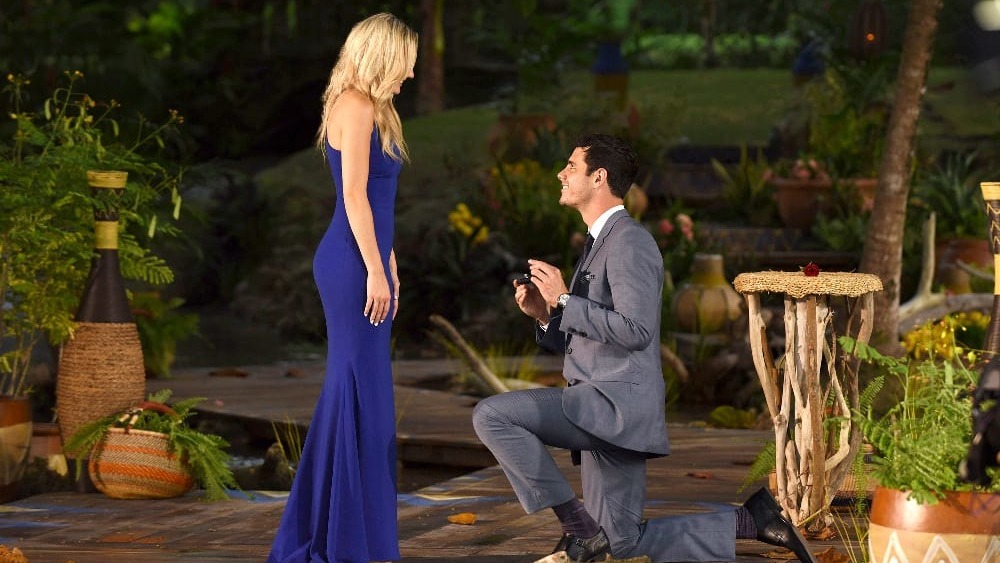 Ben Higgins, kneeling to contestant