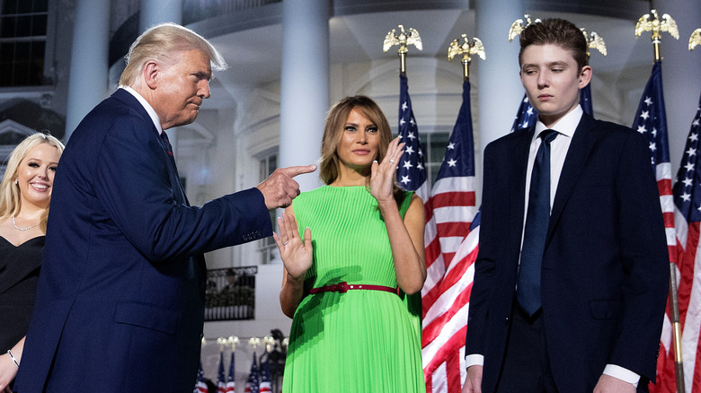 Donald Trump pointing a finger at Barron Trump on stage