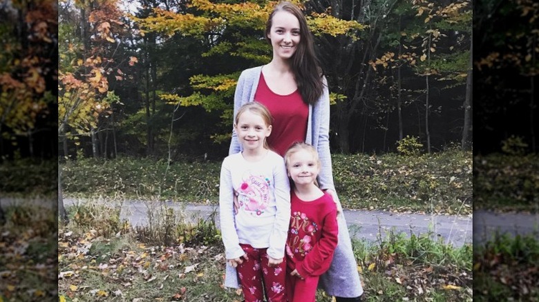 Rebecca Schmucker posing with daughters outside