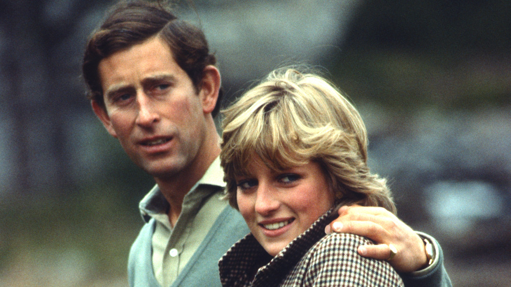 Prince Charles with his arm around Princess Diana