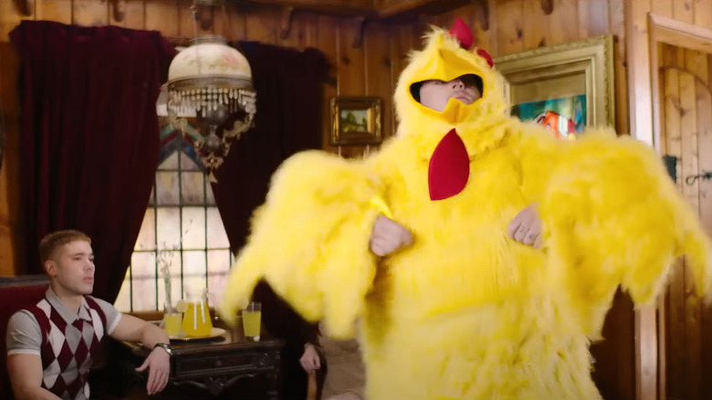 Kristos Andrews staring at Spencer Breslin in a chicken costume