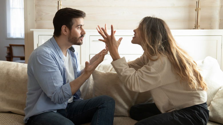 Couple arguing with hands 