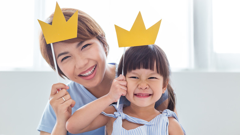 Mom and daughter with paper crowns