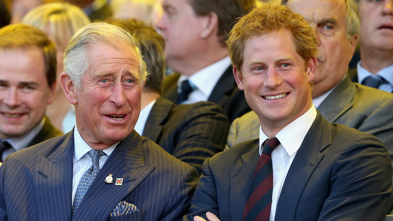 Prince Harry and Prince Charles smiling 