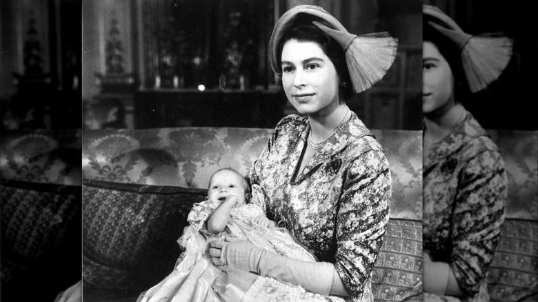 Queen Elizabeth holding baby Princess Anne