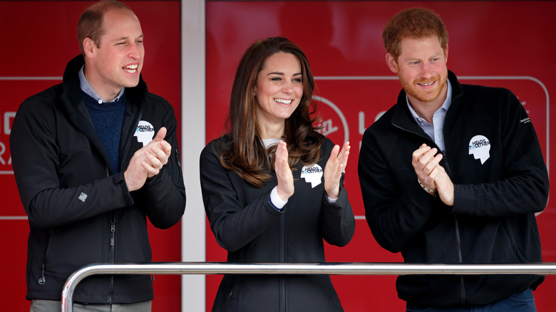 Prince William, Kate Middleton, and Prince Harry smiling 