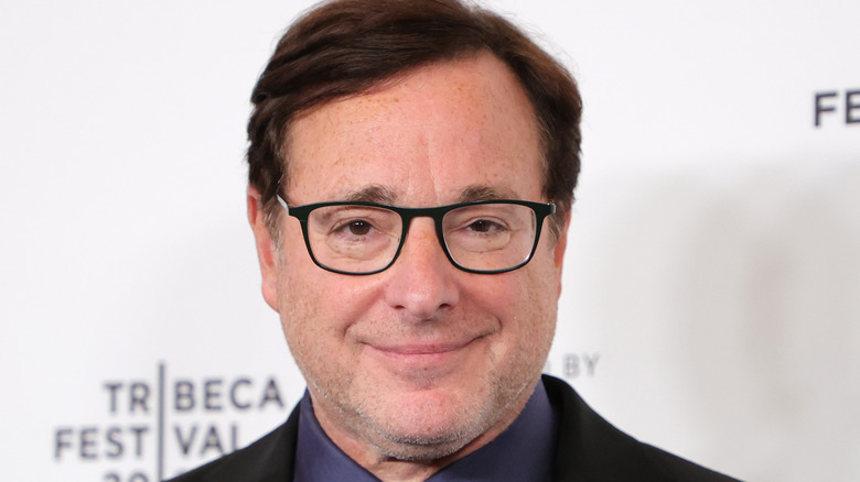 Bob Saget smiling on the red carpet