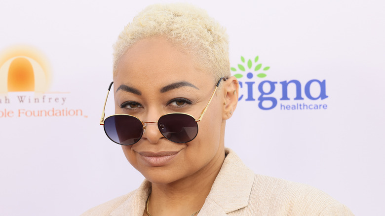 Raven-Symoné peering from behind shades