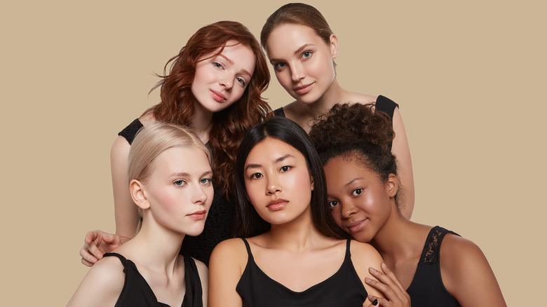 Five women with different hair posing together