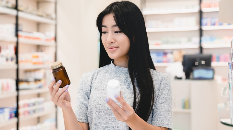 woman comparing supplements