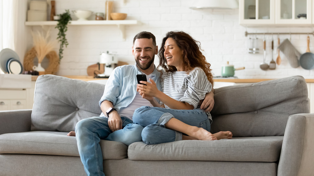 Couple together looking at a phone