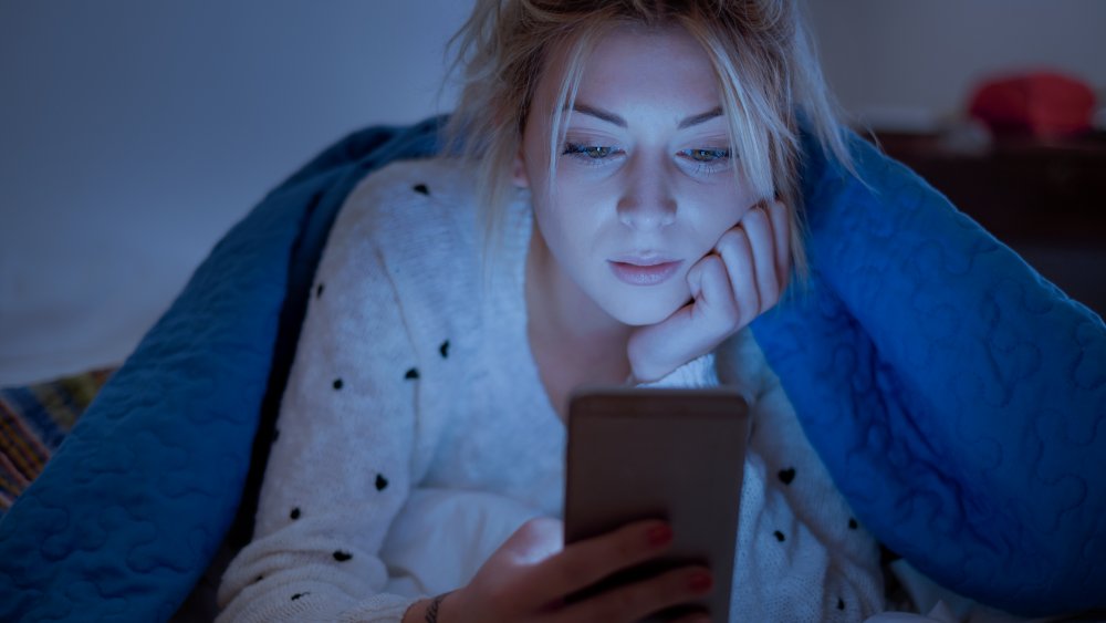 Woman on Phone in Bed