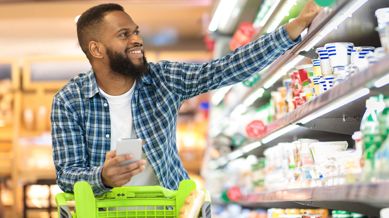 smiling man grocery shopping