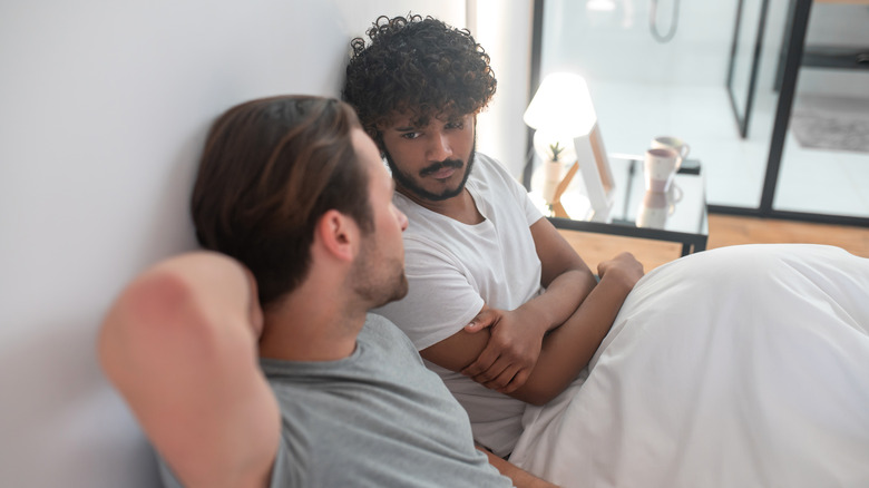 Couple talking in bed