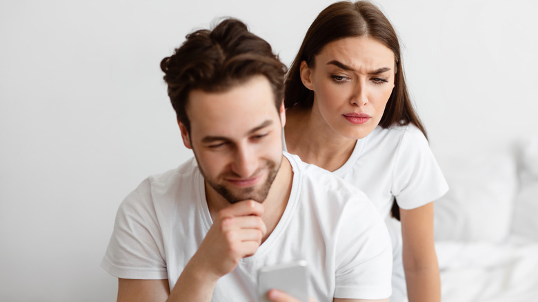 Woman looking at partner's phone