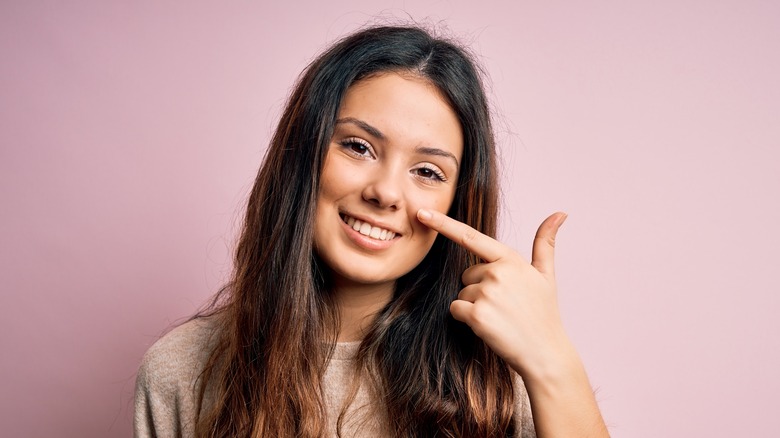 Lady pointing to her nose