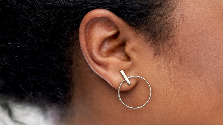 close-up on earlobe piercing