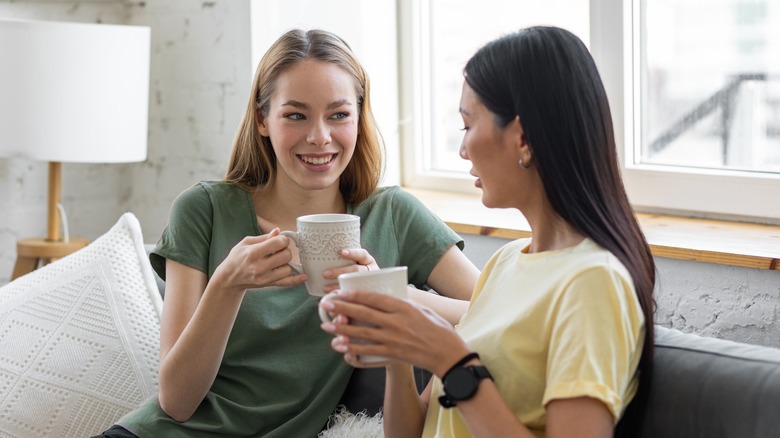 Two women holding mugs 