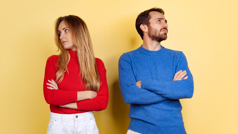 Two people with arms crossed 