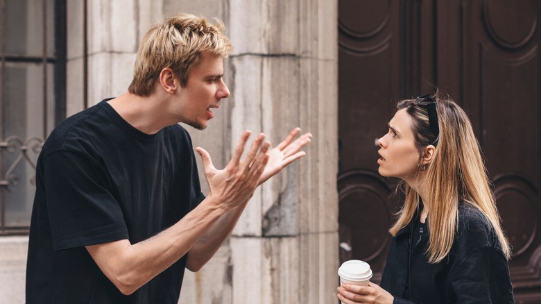 Angry couple arguing outdoors