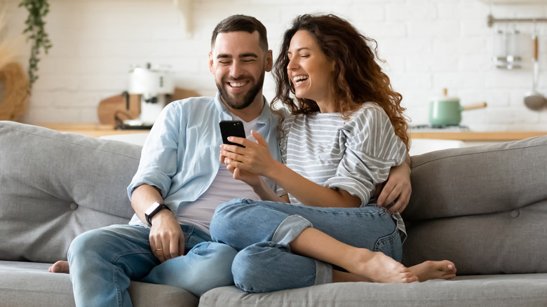 Couple smiling on sofa