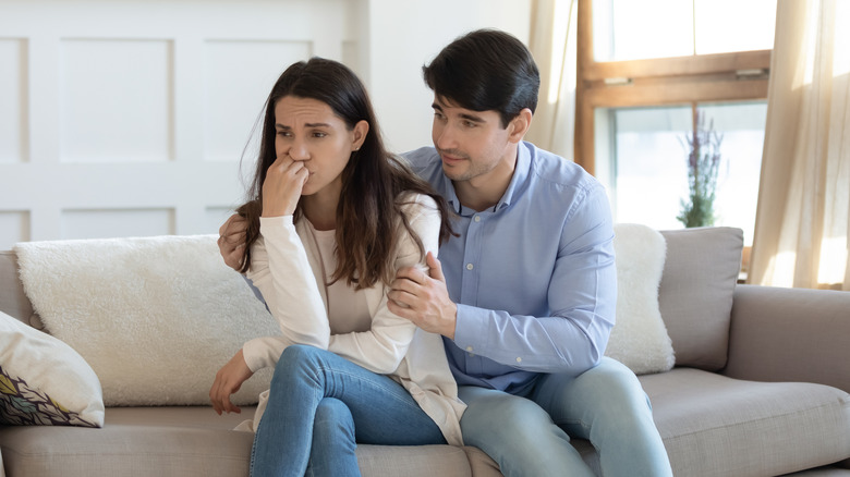 Sad couple talking after argument