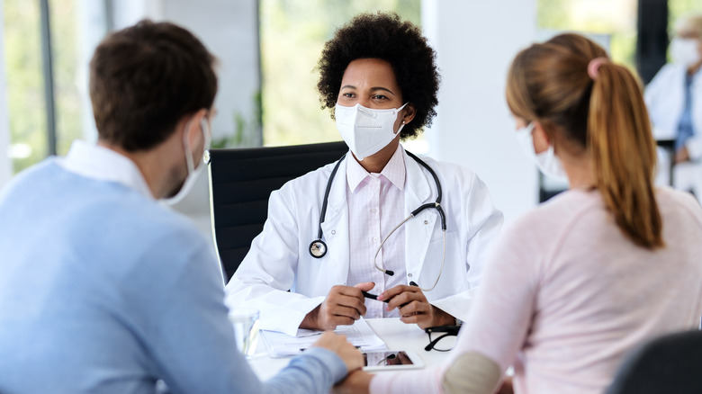 Doctor speaks with patients 