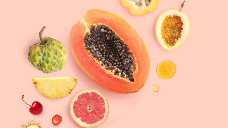 Halved fruits displayed on peach background