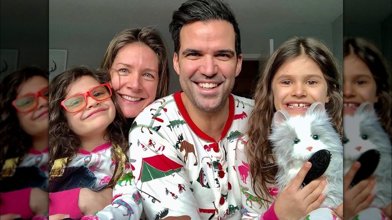 Benjamin Ayres and his wife and daughters in Christmas-themed pajamas