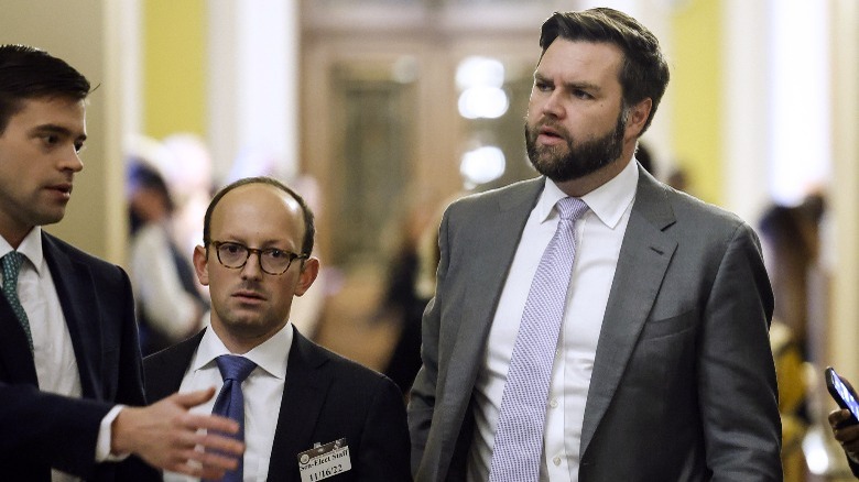 J.D. Vance and Jacob Reses walking to a meeting in suits