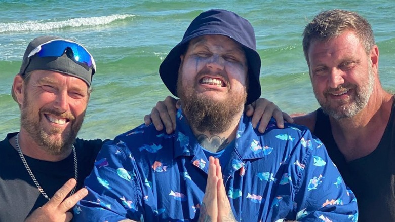 Jelly Roll posing on the beach with his two half-brothers