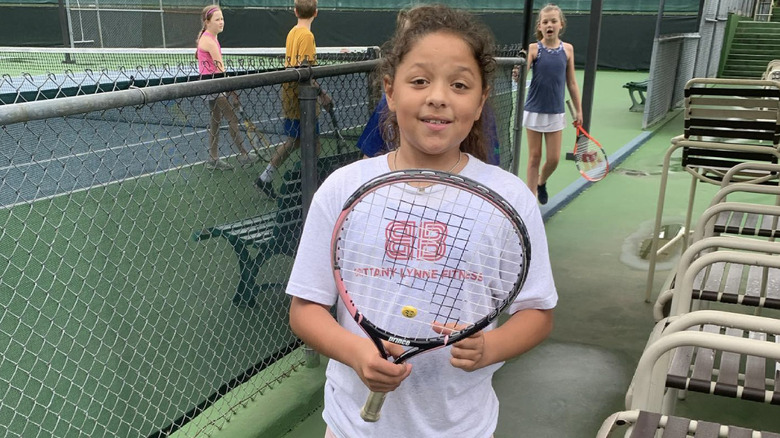 Mia Randall holding a tennis racquet