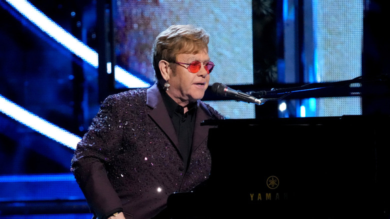 Elton John performing at piano 