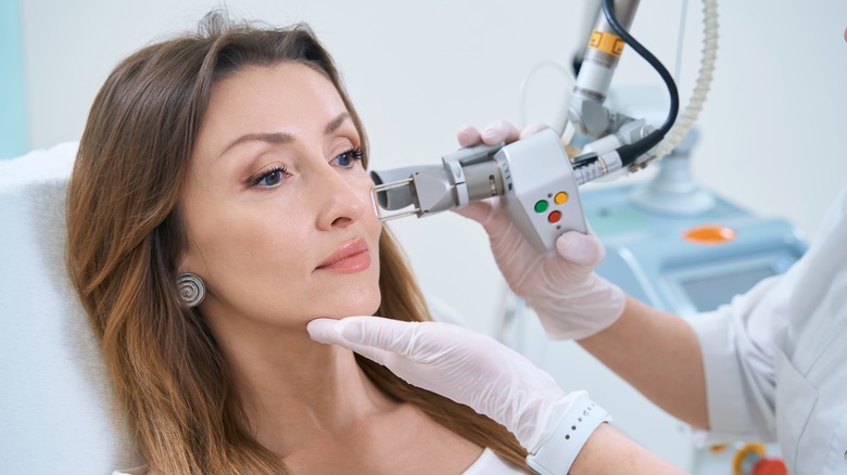 woman receiving professional acne treatment