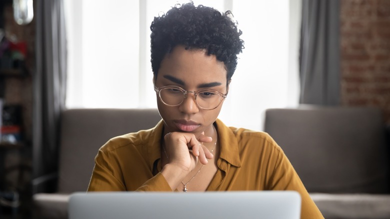 contemplating woman on laptop