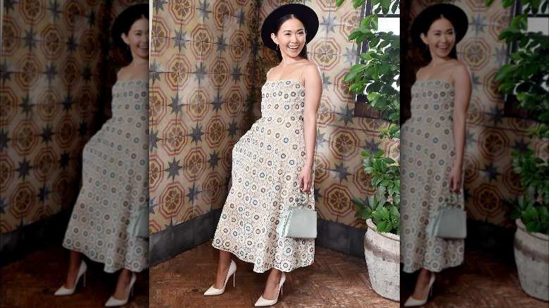 girl posing in midi dress and hat