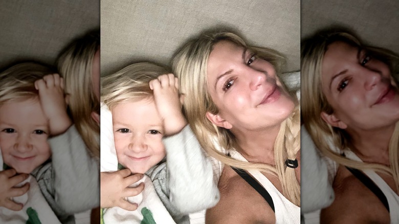 Tori Spelling posing in bed with her son