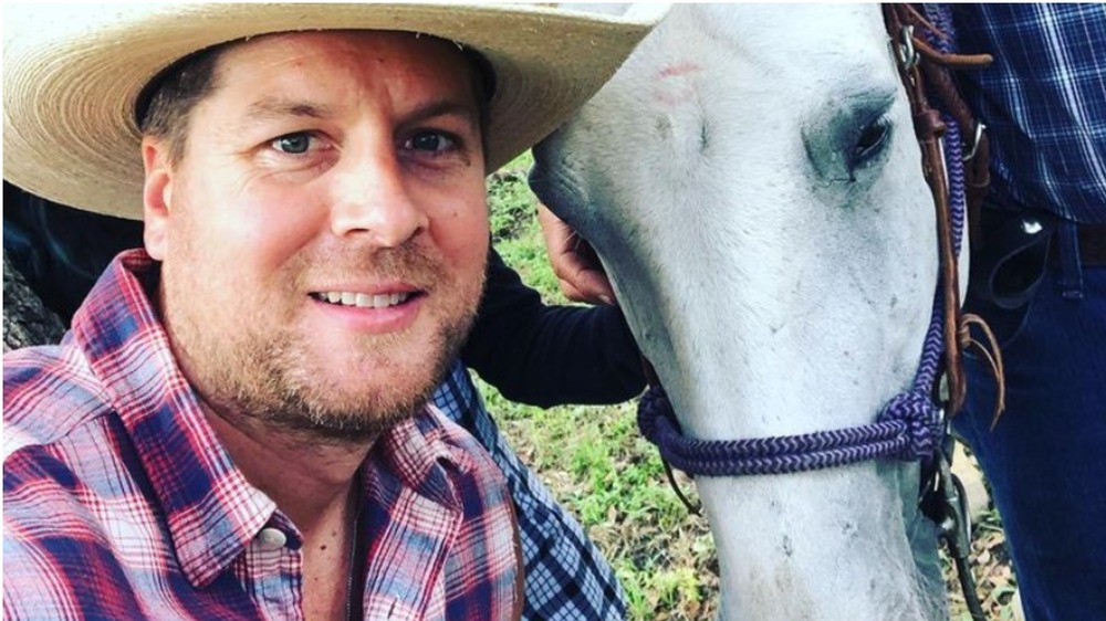 Dale Mills poses with a horse.