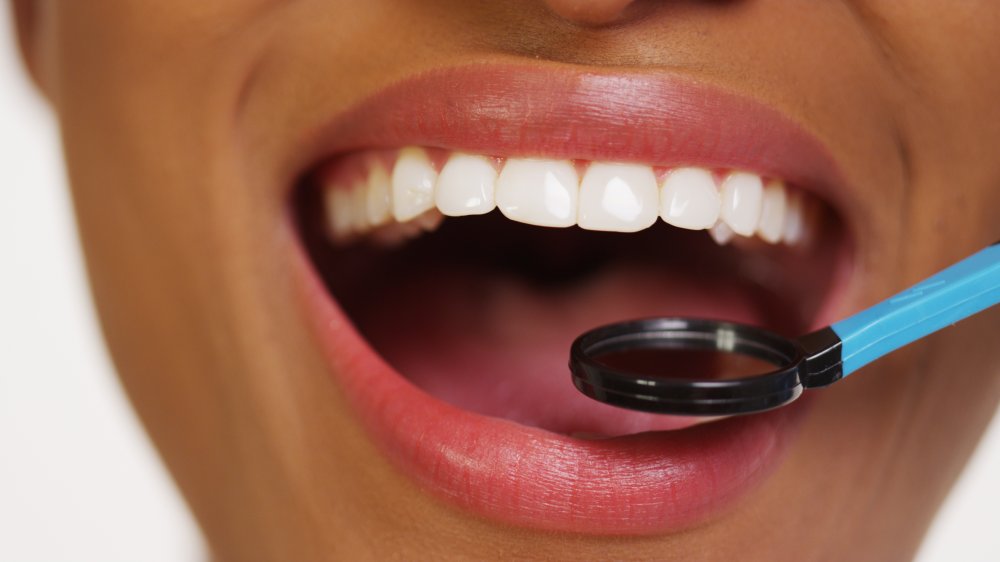 A woman having her teeth examined