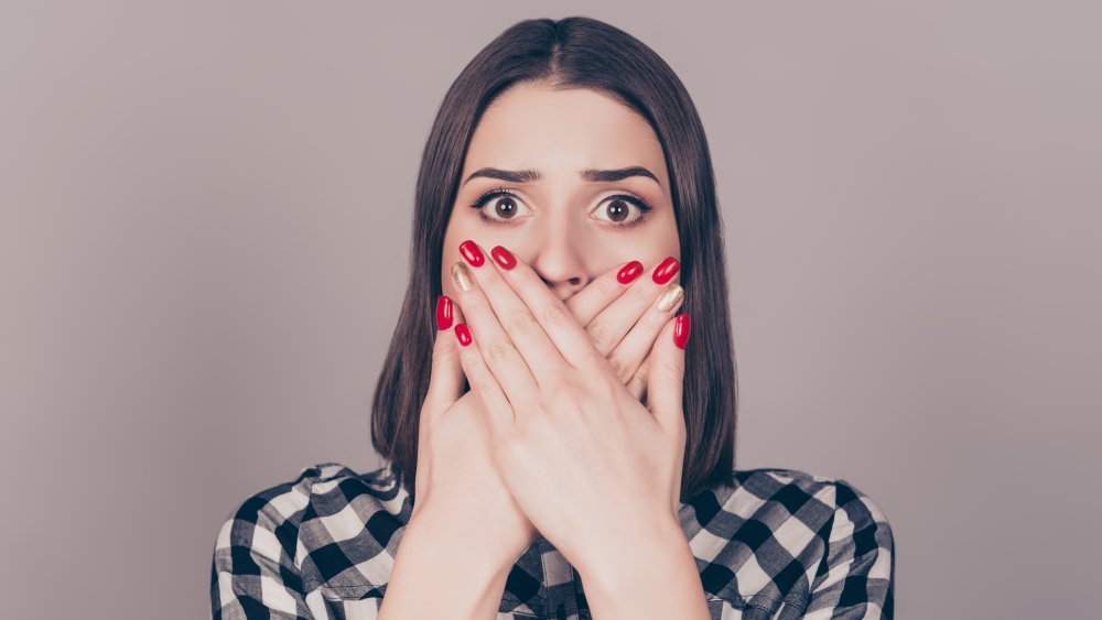 Woman covering mouth